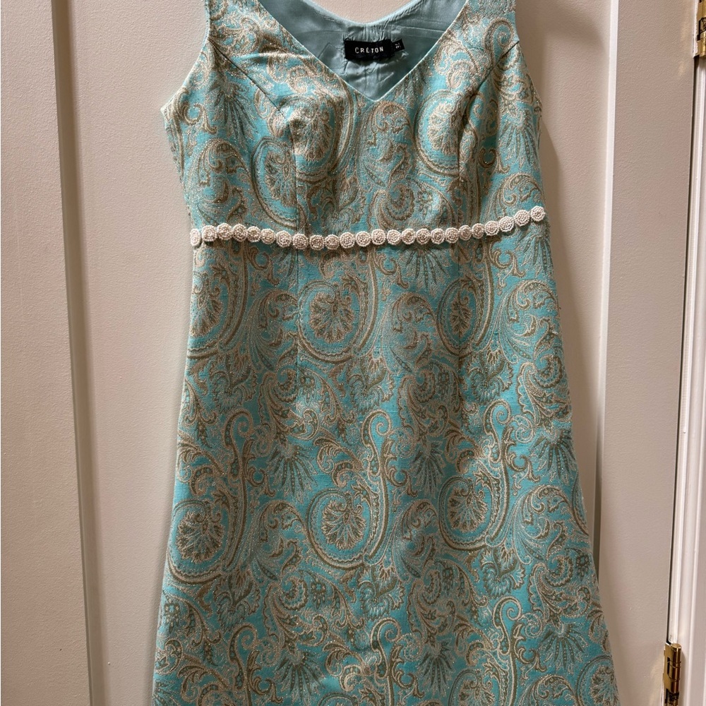 Beautiful teal colour with gold and silver threads running through it.